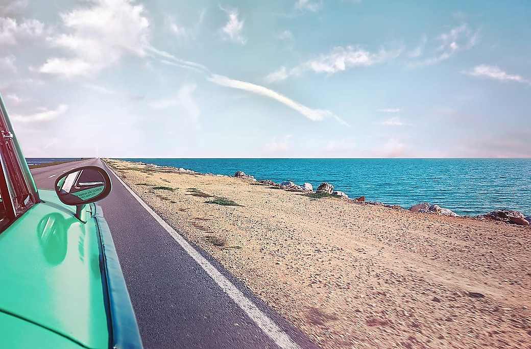 An economy car parked on a coastal road in Zanzibar